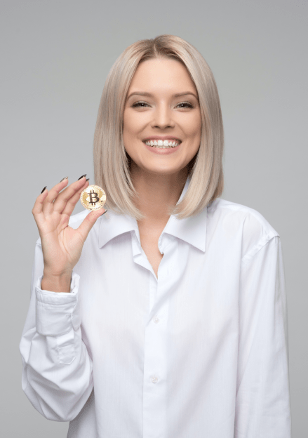 Happy woman holding a golden bitcoin coin